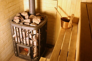 Sauna stove. The bucket is on the shelf