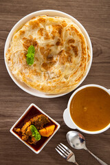 Roti Parata or Roti canai with lamb curry sauce.