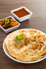 Roti Parata or Roti canai with lamb curry sauce.