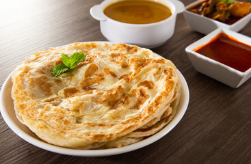 Roti Parata or Roti canai with lamb curry sauce.
