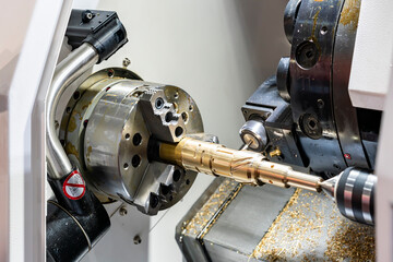 Metal brass workpiece set on spindle chuck of automatic high precision Cnc lathe turning 4 axis...