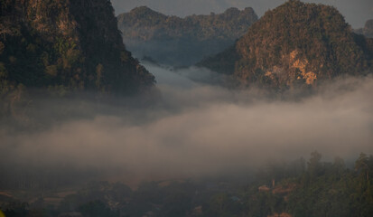 Mountain views and mist flowing through the gorge,. Mea Usu Cave, Tak in Thailand.