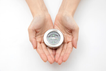 Closeup shot of hands holding a silver compas © Natalie Portman/Wirestock