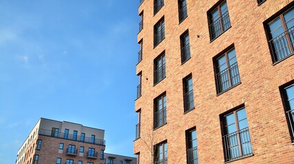 Colorful modern residential building. New luxury house and home complex of red color. City Real estate property and condo architecture.