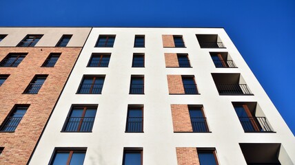 Fragment of modern luxury residential apartment,  home house building concept. Modern apartment building on a sunny day with a blue sky.