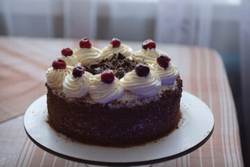 Black forest cherry cake close-up. Sponge cake with chocolate and cherries.
