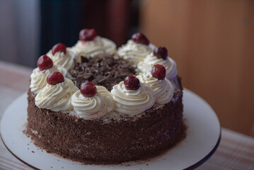 Black forest cherry cake close-up. Sponge cake with chocolate and cherries.