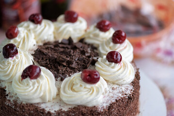 Black forest cherry cake close-up. Sponge cake with chocolate and cherries.