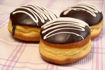 Delicious air donuts on fabric background.