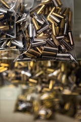Empty brass pistol cartridges, ammo in bulk on display at a gun shop, ammunition shortage in California