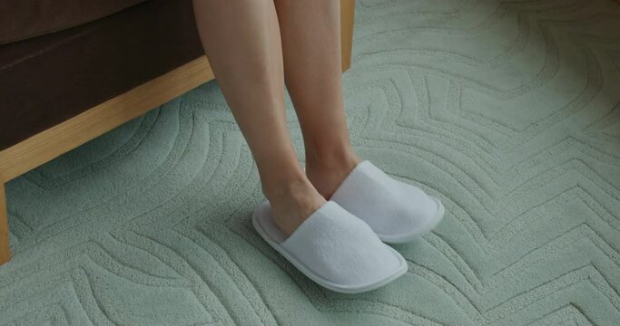 Woman wear slipper at hotel room