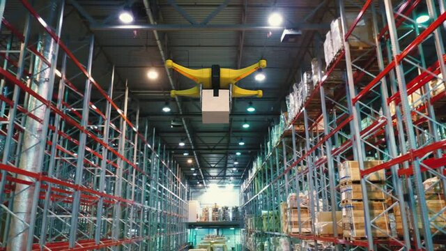 Drone with a package on a board flying inside warehouse. Delivery future concept.