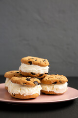 Homemade Chocolate Chip Cookie Ice Cream Sandwich on a pink plate, side view. Copy space.