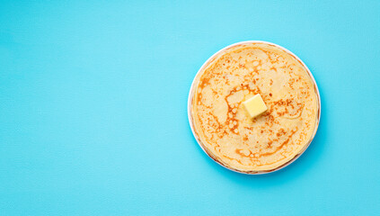 Flat lay composition with fresh thin pancakes or crepes on light blue background . Space for text