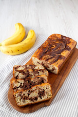 Homemade Chocolate Banana Bread on a rustic wooden board, side view. Close-up.