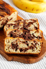 Homemade Chocolate Banana Bread on a rustic wooden board, side view. Close-up.