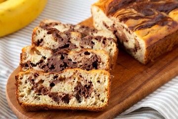 Homemade Chocolate Banana Bread on a rustic wooden board, side view. Close-up.