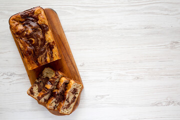 Homemade Chocolate Banana Bread on a rustic wooden board, top view. Flat lay, overhead, from above. Space for text.