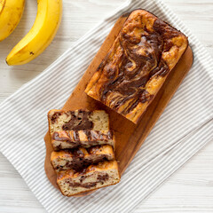 Homemade Chocolate Banana Bread on a rustic wooden board, top view. Flat lay, overhead, from above.