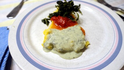 A plate of polenta with gorgonzola cheese sauce