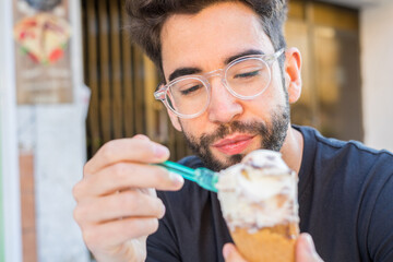 Young man eating ice cream