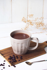 cup of hot chocolate with white wooden background