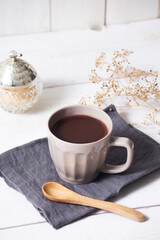 cup of hot chocolate with white wooden background