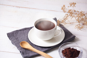 cup of hot chocolate with white wooden background