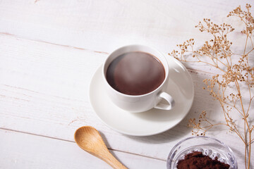 cup of hot chocolate with white wooden background
