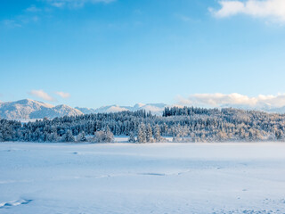 Fototapeta na wymiar Winter landscape with mountains lake and fog