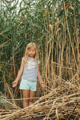 little girl on the high  grass