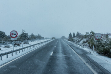 Vertical traffic signs forbidden to overtake trucks with snow on a day of adverse weather due to...