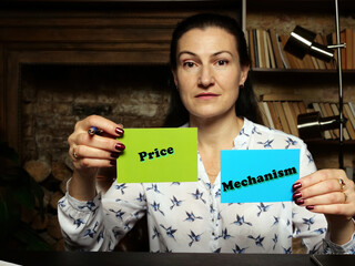 Young Woman holding a blank cards in hands. Conceptual photo about Price Mechanism with written text.