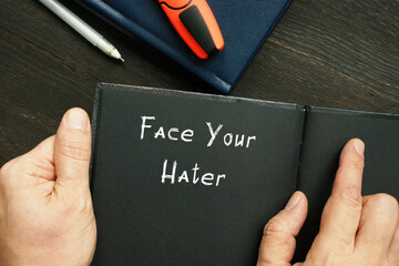 Motivational concept about Face Your Hater with inscription on the page.