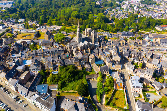 Flight over the city Guingamp and Basilica of Our Lady of Merciful on summer day. France