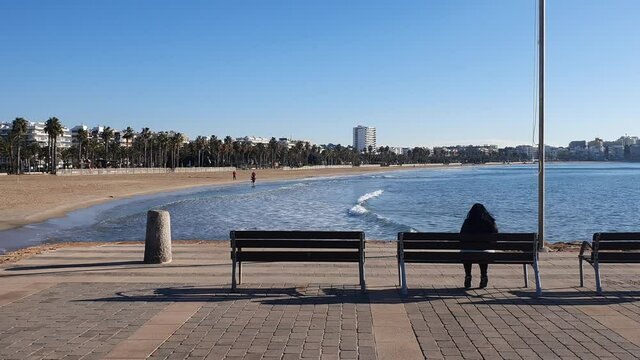 View from behind person seating on the bench in Salou