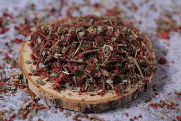 dried strawberries with a stalk and a leaf are on the table