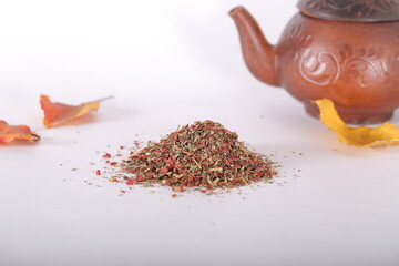 dried strawberries with a stalk and a leaf are on the table