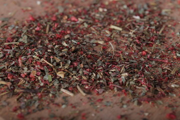 dried strawberries with a stalk and a leaf are on the table