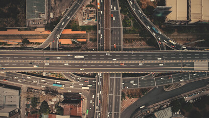 Cross highway top down at Philippines capital cityscape aerial shot. Cars, buses, vans, trucks are...