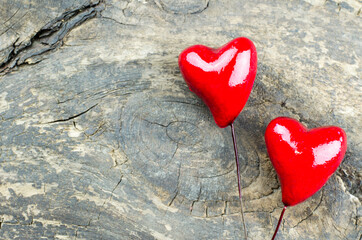 Valentine's Day background. Two red hearts on a wooden background.
