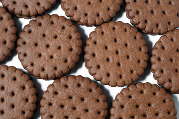 Texture background of rows of chocolate-cream cookies.