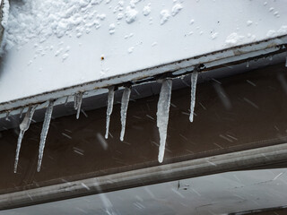 Ice stalactites hanging from a ledge