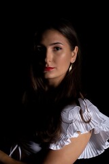 Naklejka premium Young Woman in a black dress dancing, Young professional dancer practicing in a studio , dancer
