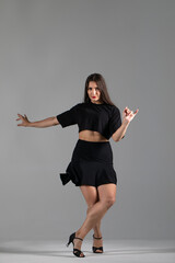 Young Woman in a black dress dancing, Young professional dancer practicing in a studio , dancer