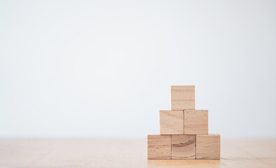 stacking blank wooden cubes on table with copy space for input wording and infographic icon.