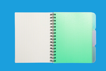 green notebook on a blue background