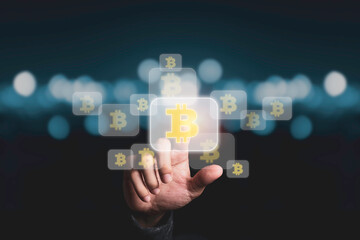 Hand touching bitcoins symbol with blue bokeh, bitcoin is crypto currency for exchange in the future.