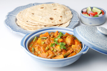 Mix vegetables curry of beans, carrot potato and green peas with Roti and salad. Indian food