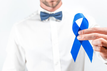 Blue ribbon. Awareness prostate cancer of men health in November. Hipster men in bright shirt, cyan...